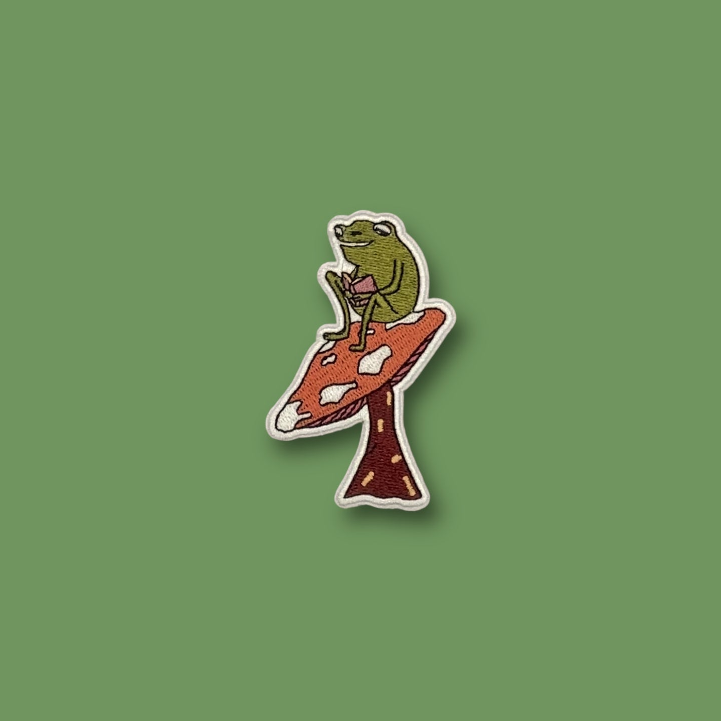 Reading On A Mushroom Frog Patch